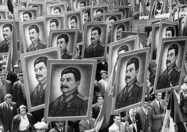 Citizen marchers carrying posters of joseph stalin at a may day parade in bucharest, romania, 1950s.
