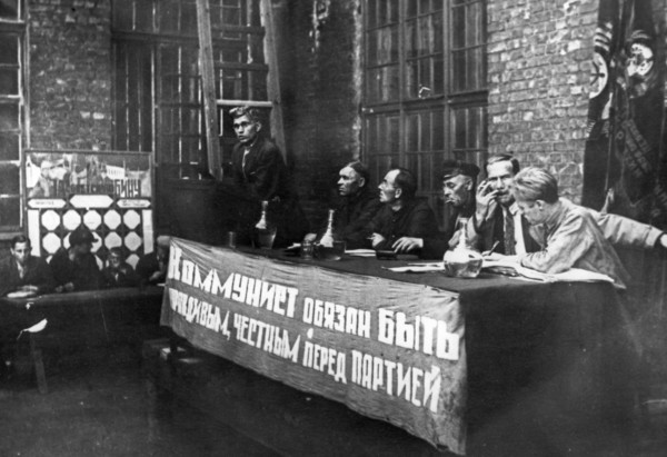 Comrade solovyov, the secretary of the communist party branch at the krasny putilovets plant, undergoing questioning duing the campaign to cleanse the cp of hostile elements, leningrad, 1933, the bann...