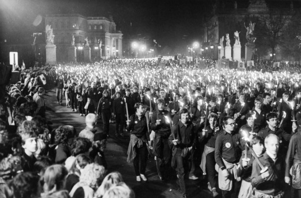 A torchlight procession of free german youth organization members in honor of the 35th anniversary of the gdr on unter der linden avenue in berlin, october 10, 1984.