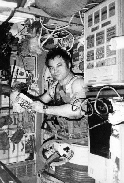 Soviet cosmonaut yuri romanenko wearing the chibis vacuum suit aboard the mir orbital space station, soyuz tm-2, 1987.