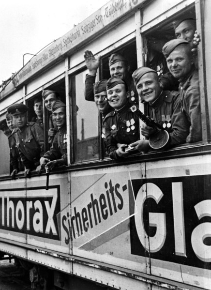 Soviet soldiers riding a berlin tram, 1945, after germany's surrender.