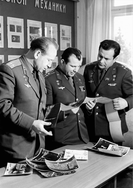 Soviet cosmonauts alexei leonov, yuri gagarin and pavel popovich looking at printed photo transmissions from the luna 9 moon probe, 1965.