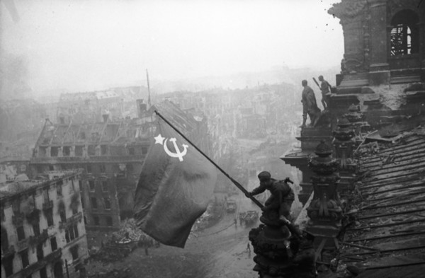 Red army soldiers raising the soviet flag over the reichstag in berlin, germany, april 30, 1945.