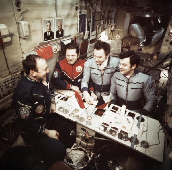 The crews of soyuz 26 and soyuz 28 missions (vladimir remek, alexei gubarev, oleg makarov and georgi grechko) open mail aboard the salyut 6 space station, march 1978.