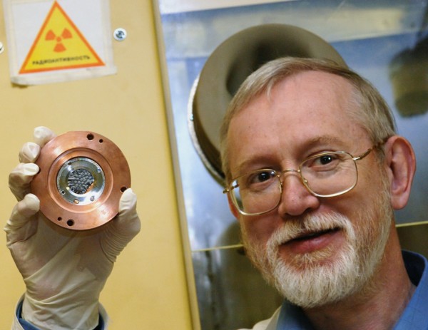 Candidate of chemical sciences, sergei shishkin holding up the plutonium target that was used in a recent research carried out at the joint institute for nuclear research to confirm the chemical compo...