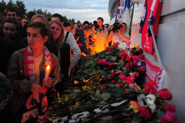Yaroslavl, russia, september 7, 2011, lokomotiv yaroslavl fans lay flowers outside arena-2000 stadium to commemorate players of a khl ice hockey team lokomotiv who died in a yak-42 passenger plane cra...