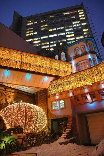 A restaurant in arbat street is illuminated at night, moscow, russia, march 2007.