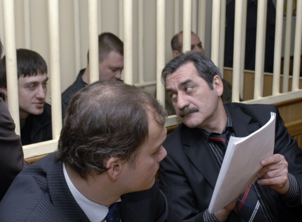 Dzhabrail makhmudov, pavel ryaguzov and sergei khadzhikurbanov (l-r, background), accused of murdering anna politkovskaya, novaya gazeta columnist, appear at the hearing of moscow district military co...
