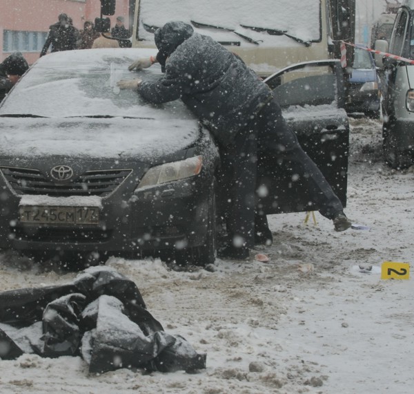 Moscow, russia, december 29, 2008, the body of tax crimes police officer roman maslov lies near his toyota car in which he was shot dead in the yard of his house.