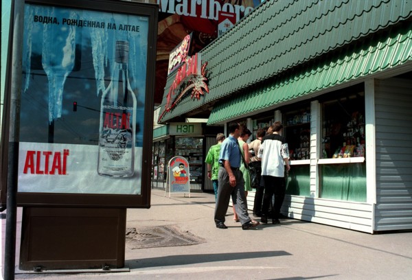 Moscow, russia, 2000, a poster (left) advertising a vodka distilled in the altai territory, and (right) a kiosk selling light alcoholic drinks and beer.