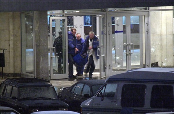 Moscow, russia, october 26 2002: chechen hostage crisis, a dead body is carried out of the theater center, presumably it is the body of the man who entered the building tonight, probably a relative of...