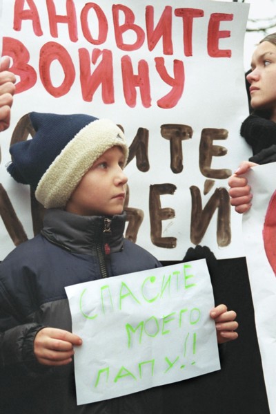 Moscow, russia, october 25 2002: a little boy whose father is being held hostage by terrorists at the palace of culture of the ball-bearing plant pictured participating in mass meeting of relatives of...