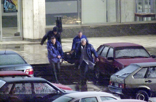 Moscow, russia,10/26/02: chechen hostage crisis: a dead body is carried out of the theater center, presumably it is the body of the man who entered the building tonight, probably a relative of a hosta...