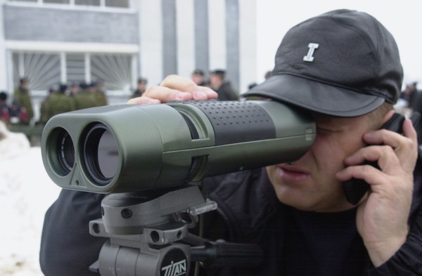 Moscow region, russia, november 15 2002: a visitor to the exhibition trying a piece of equipment for detecting optical devices in use, the demonstration was held on friday within the framework of the ...