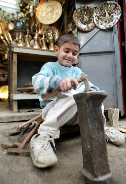 Baghdad, iraq, february 10 2003, a young craftsman pictured at work in a street of old baghdad.