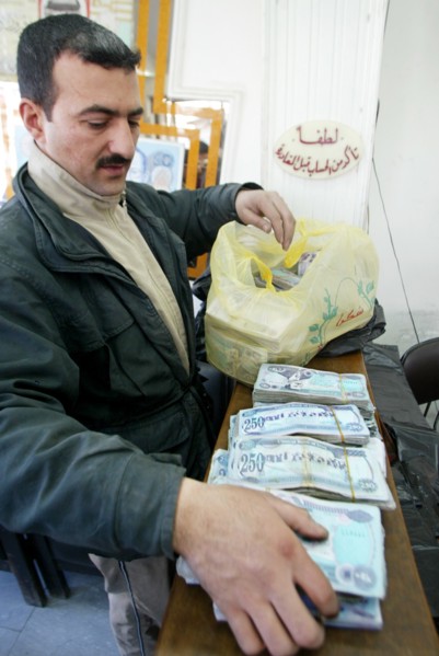 Baghdad, iraq, february 14 2003: an exchange office in baghdad, money is brought here in sacks because of the low price of the national currency - dinar, (photo itar-tass / vitaly belousov)  .