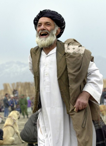 Kabul, afghanistan, march 9 2003 a fan shouts when watching dog fights that remain one of the chief attractions in kabul, the fights draw thousands of spectators, in case it wins, an asian sheepdog ma...