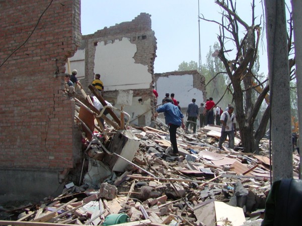 Chechnya, russia, may 12, 2003, people pictured clearing the debris in the village of znamenskoye where a powerful explosion ruined the buildings that housed the district administration ,on monday , m...