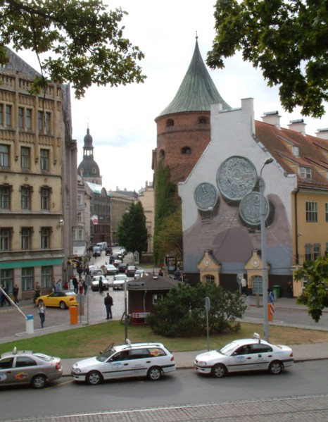 Smilsu street, a business area in old riga, latvia, the powder tower (r) and the dom cathedral (in the background), the coins depicted on the right part of the building are lats, the modern latvian cu...