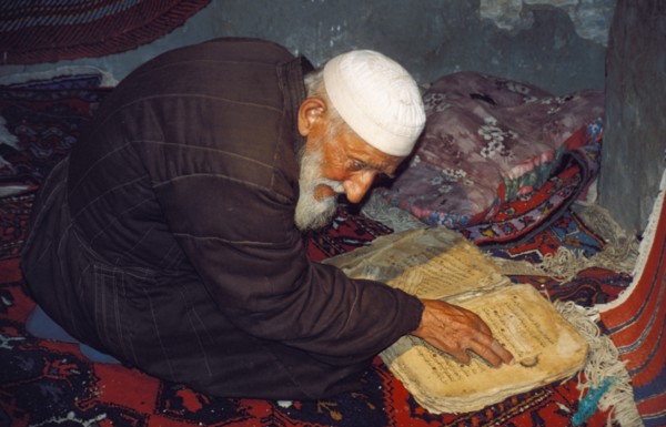 An old islamic man praying in a mosque in daghestan, russia.