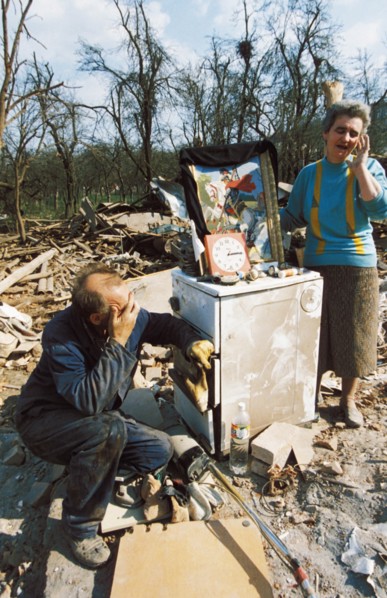 A serb couple sitting in the ruins of their home in cacak (170 km from belgrade) after a nato air strike, yugoslavia, april 1999.