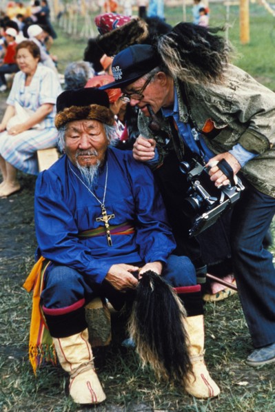 A folk performer and a photographer during the yakut folk festival, 'ysyakh', siberia, russia.