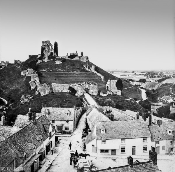 A black and white historic image of a city with a landmark on a hilltop