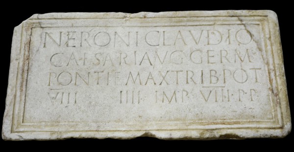 Stone plaque dedicated to emperor Nero (Nero Claudius Caesar Augustus Germanicus)  (37-68 AD) honouring his person and lists his titles: Pontifex Maximus, Tribune, Consul, Emperor and Father of the Ho...