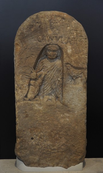 Roman funerary stele dedicated to a deceased girl, depicted in a niche with a full-length tunic and a cloak