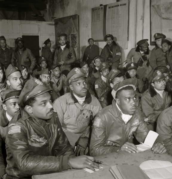 Several Tuskegee airmen attending a briefing in Ramitelli, Italy, March 1945