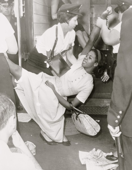 African American woman being carried to police patrol wagon