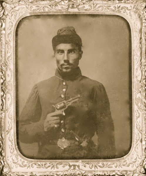Seated black soldier with pistol and jacket