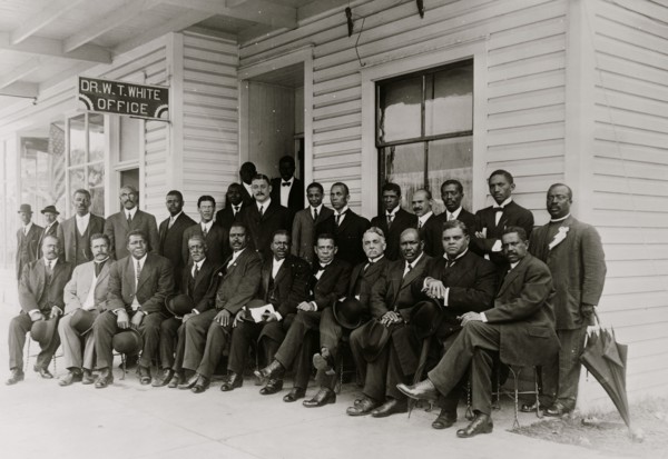 Booker T. Washington seated with group of men
