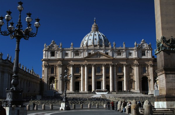 Tourists in St. Peters Square and Basilica of St. Peters.
