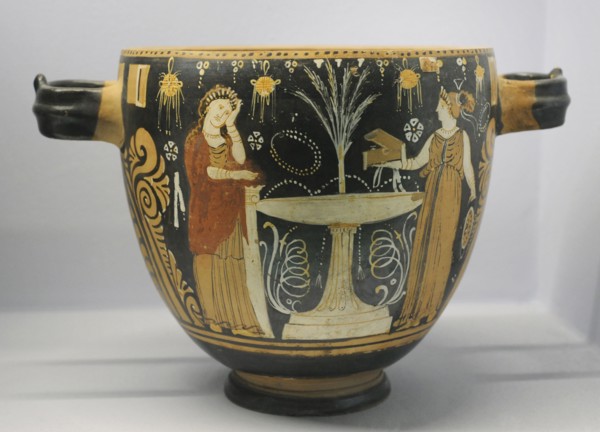 Pyxis depicting two women in a toilette next to a louterion.
