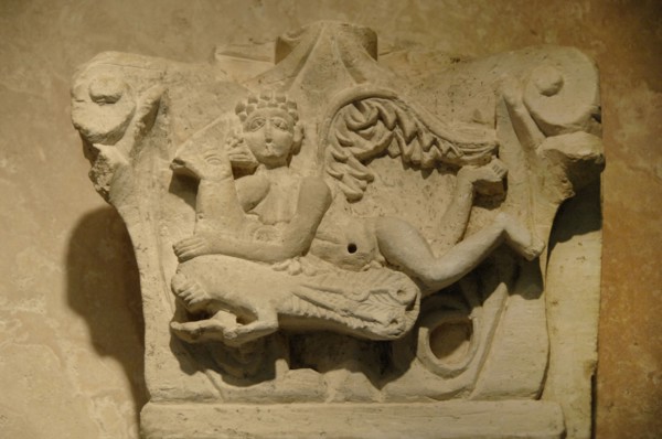 Capital decorated with relief of cupid on a peacock.