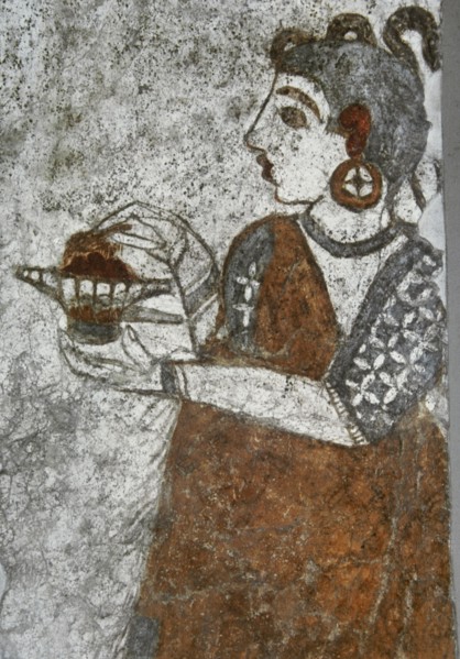 Priestess making offerings.