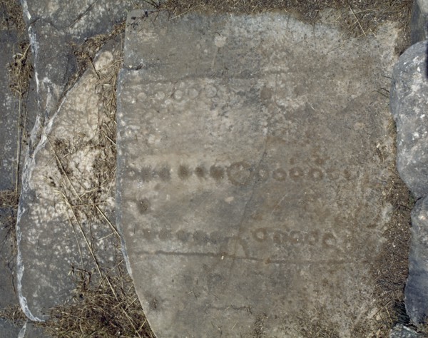 Roman games engraved into seats of the stadium, upper bleachers.
