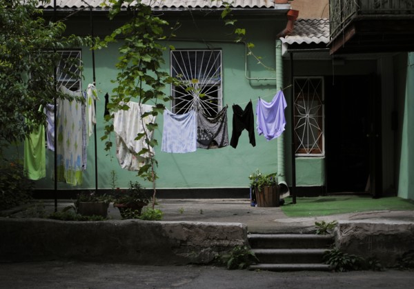 Interior of a typical yard of a house with laundry clothes drying.