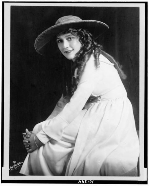 1921 -Mary Pickford, three-quarter length portrait, seated, facing left