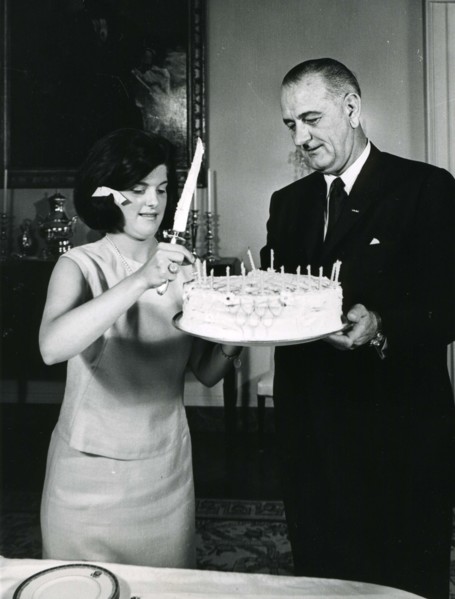 White House, July 2, 1964 -- Luci B. Johnson,accompanied by her father President Lyndon B. Johnson, prepares to cut the cake at her 17th birthday party. Photo: Abbie Rowe