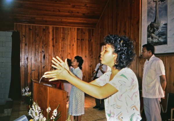 (R) Woman singing during a worship service in a small church in Honduras circa 1987.