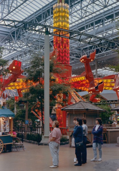 Women watch their children and grandchildren on a ride at the Mall of America circa 1994-1996.