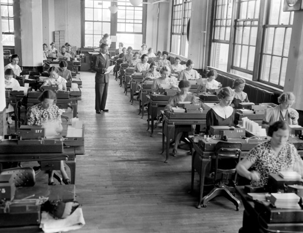 Social Security Board Records Office -  Workers at work in part of the key machine section, where master cards are punched circa 1937.
