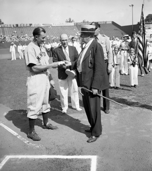 Jake Powell, New York Yankee outfielder, was presented with a wallet today as a token of esteem from fans of Laurel, MD, where he played as a semipro circa 1937.