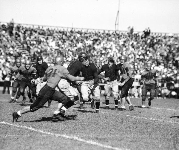 A Navy defensive back is tackled after intercepting a William & Mary pass 9/25/1936.