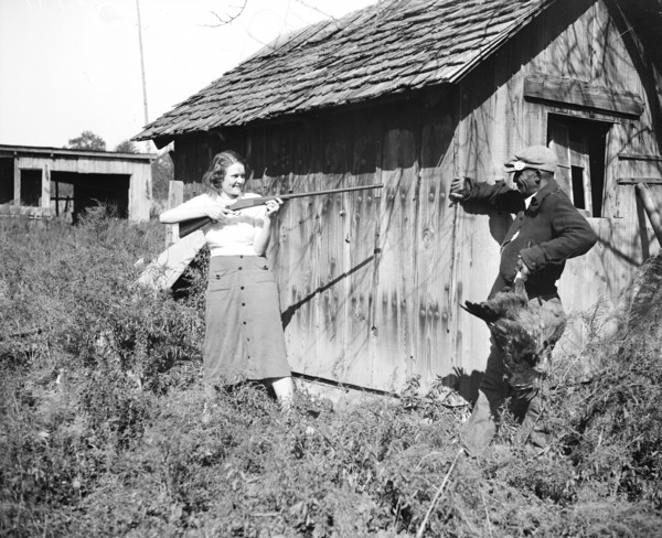 Edna Morris, who lives within a few hundred feet of the government-owned 'Tugwelltown' being constructed near Washington by Rehabilitation Administration, arms herself to protect her property against ...