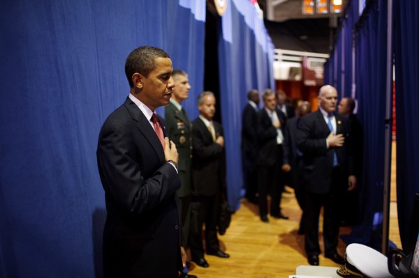 Before giving a policy speech on Iraq, President Barack Obama places his hand on his heart as the national anthem is played backstage  at the Field House, Camp Lejeune, North Carolina 2/27/09. .