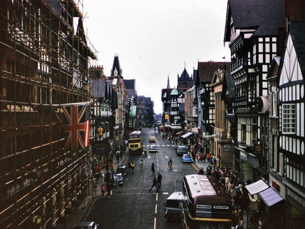 Buses and traffic on a street in Chester England circa July 1973.