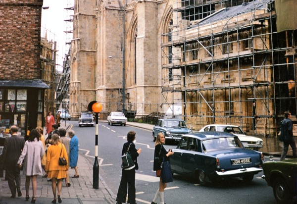Pedestrians waiting to cross the street in York, England circa 1973.